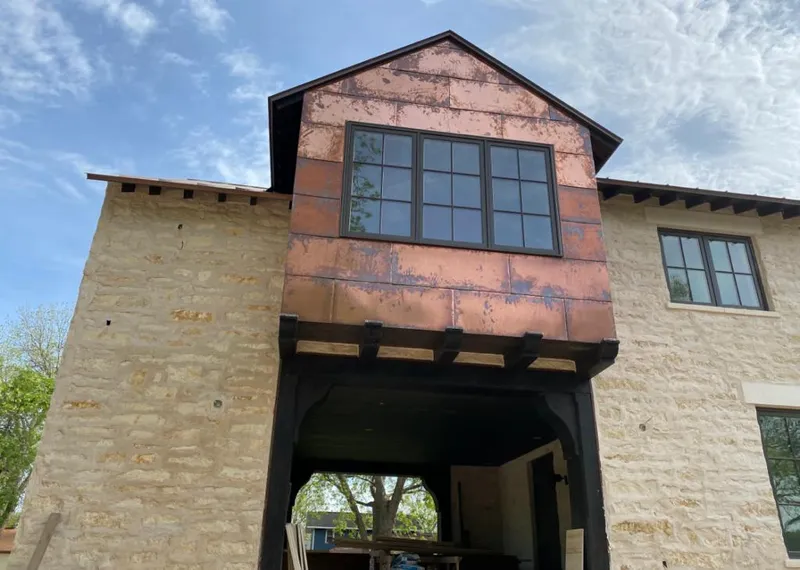 Copper metal panel facade on a stone building for Metal Roof Coating in Wentzville